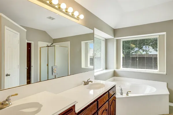 a bath room with a sink and a mirror