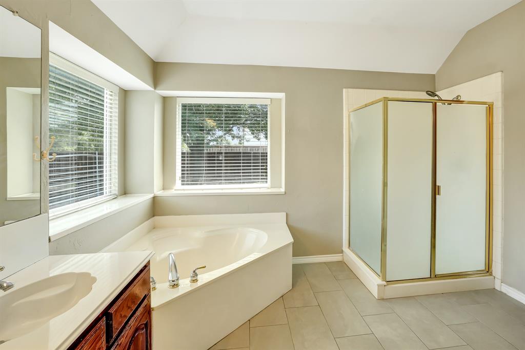 1315 Ballantrae Drive Allen, TX 75013 - Photo 16 of 26 a spacious bathroom with a tub sink and mirror