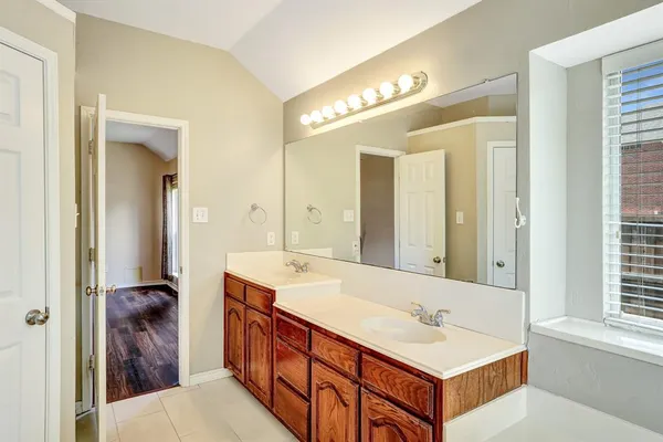 a bathroom with a double vanity sink and a mirror