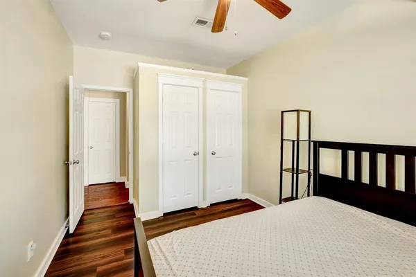 a bedroom with a bed and wooden floor