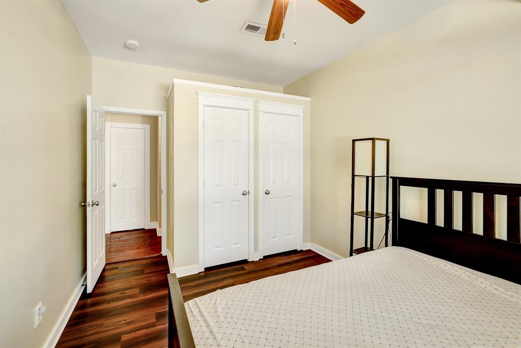 1315 Ballantrae Drive Allen, TX 75013 - Photo 18 of 26 a bedroom with a bed and wooden floor