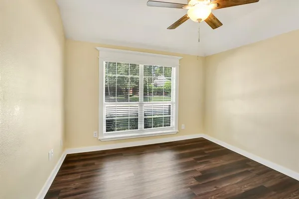 a view of wooden floor and windows in a room