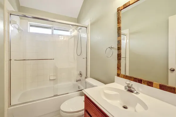 a bathroom with a sink mirror toilet and bathtub