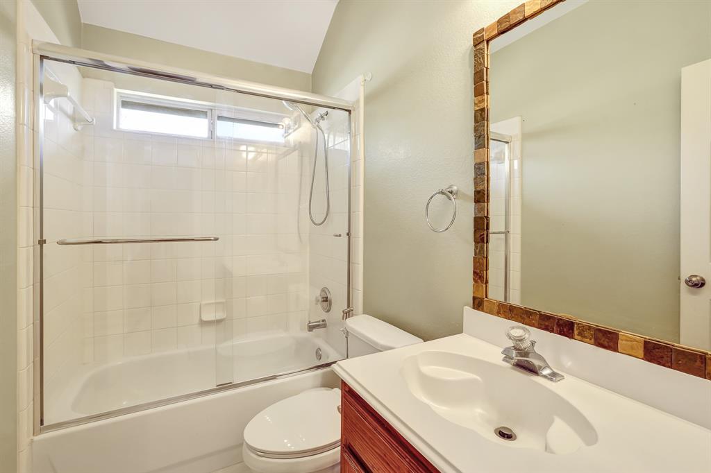 1315 Ballantrae Drive Allen, TX 75013 - Photo 22 of 26 a bathroom with a sink mirror toilet and bathtub