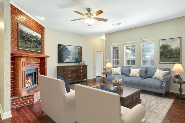 a living room with fireplace furniture and a flat screen tv