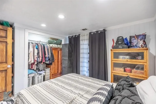 a bedroom with a bed and a walk in closet