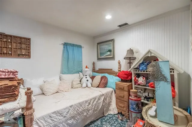 a bedroom with bed and a wooden floor