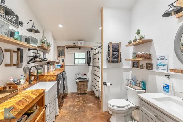 a bathroom with a sink a toilet and a mirror