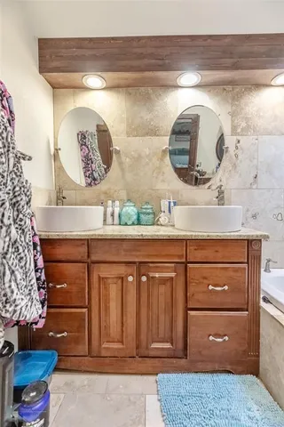 a bathroom with a double vanity sink and a mirror