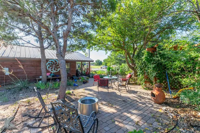 a view of a porch with chairs and backyard