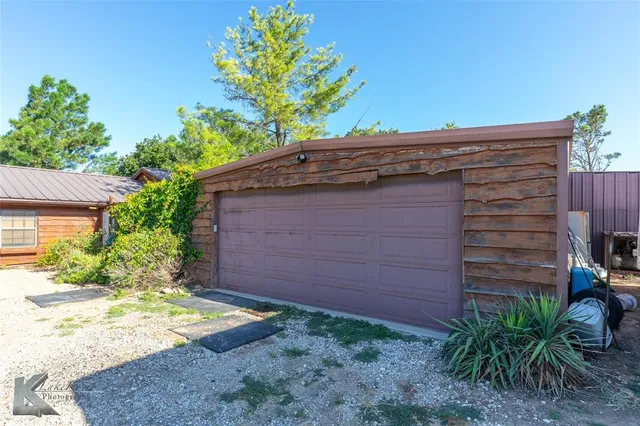 a view of a yard with a table and a chairs