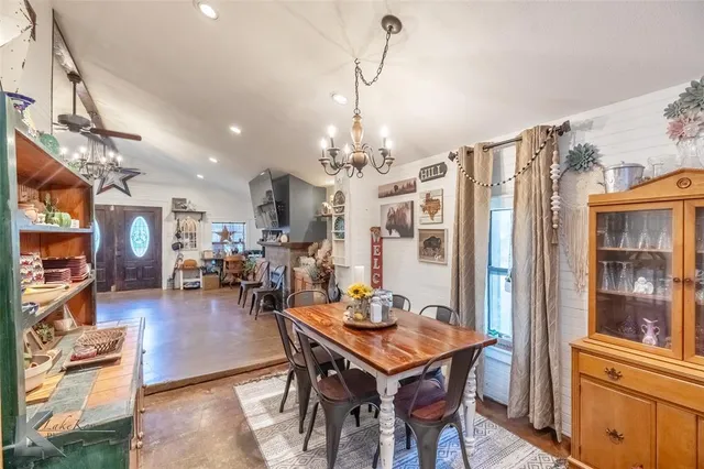 a view of a dining room with furniture and chandelier