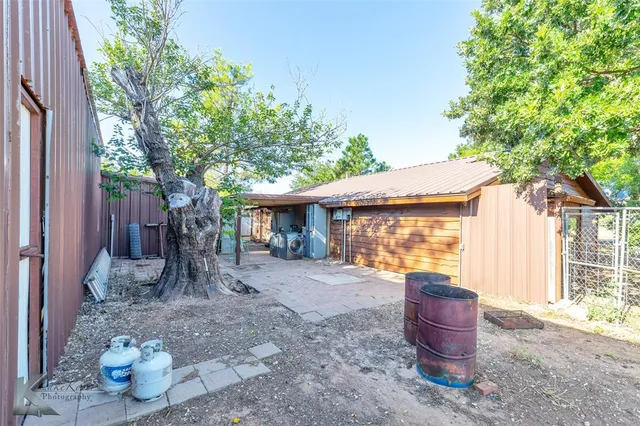 a front view of a house with table and chairs