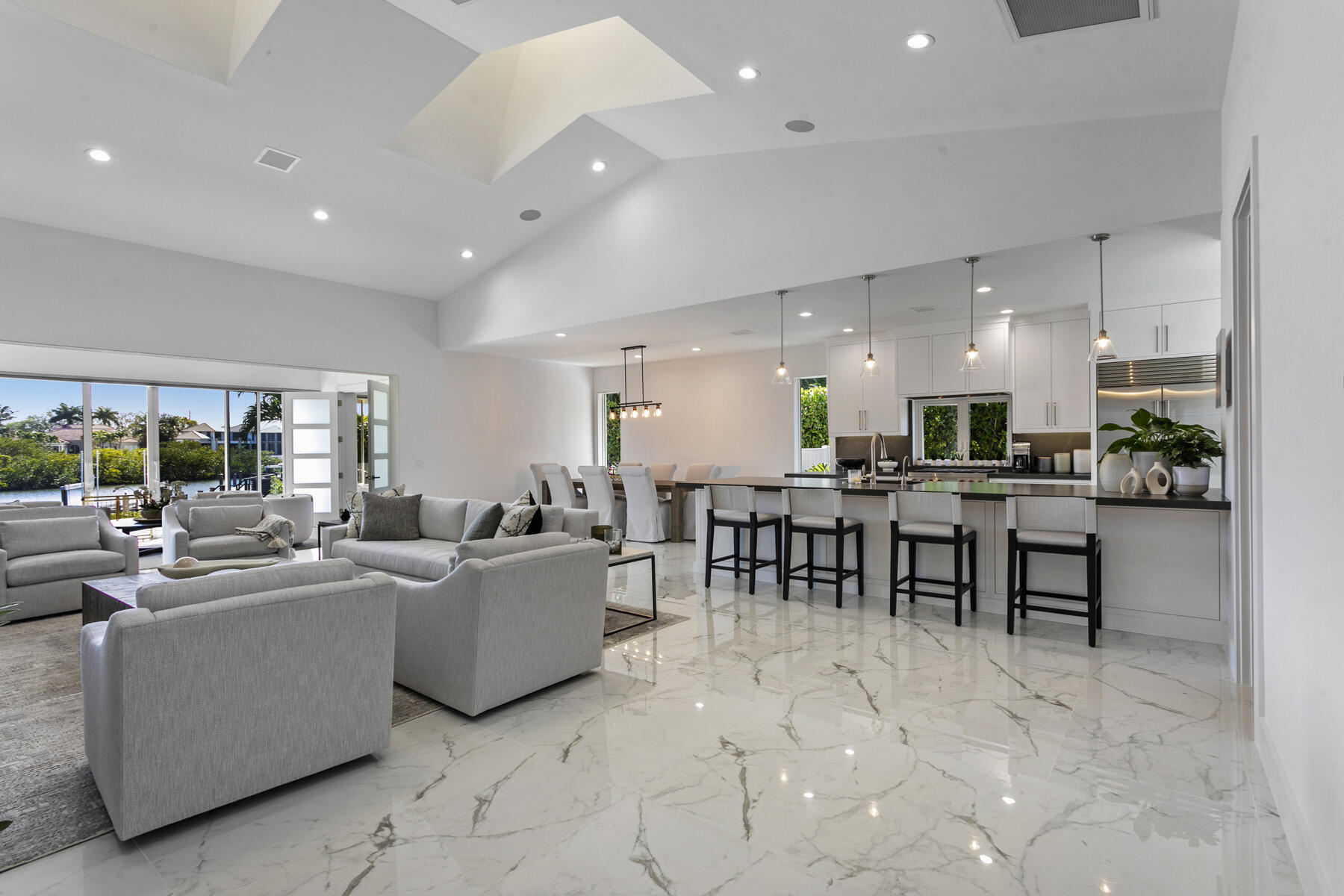 245 Regatta Drive Jupiter, FL 33477 - Photo 11 of 51 a living room with furniture a table and chairs