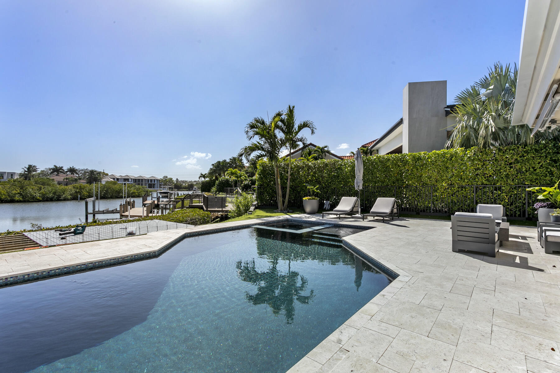 245 Regatta Drive Jupiter, FL 33477 - Photo 40 of 51 a view of a swimming pool with outdoor seating and plants