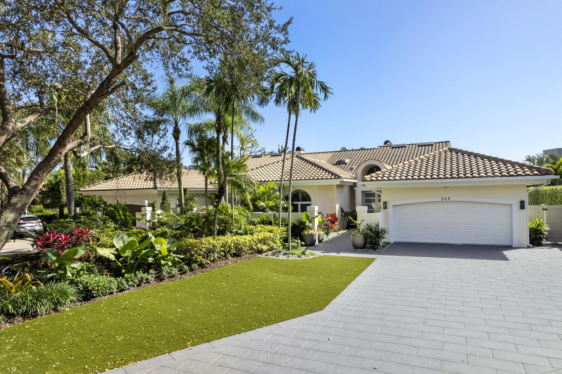245 Regatta Drive Jupiter, FL 33477 - Photo 4 of 51 a view of a house with a yard and potted plants