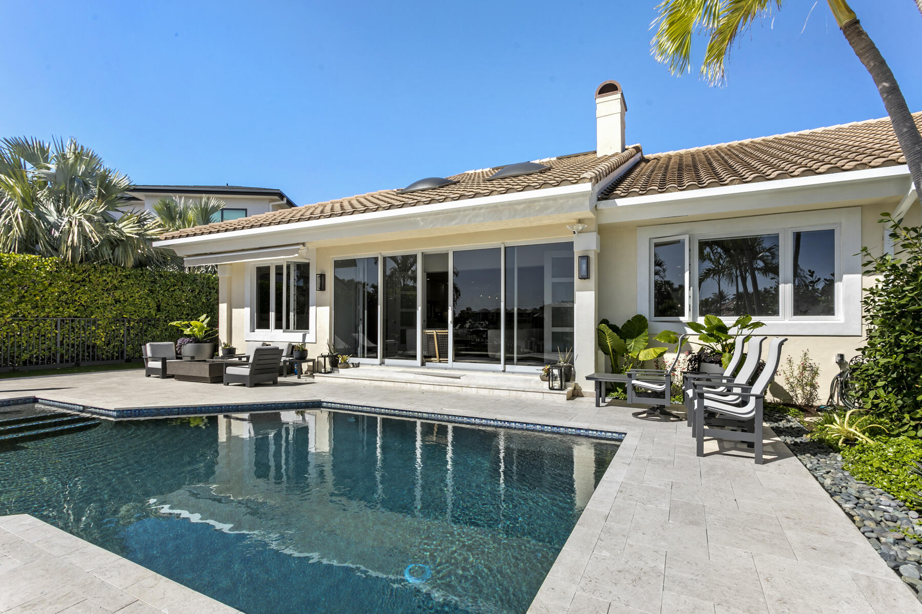 245 Regatta Drive Jupiter, FL 33477 - Photo 42 of 51 a view of a house with sitting area and swimming pool