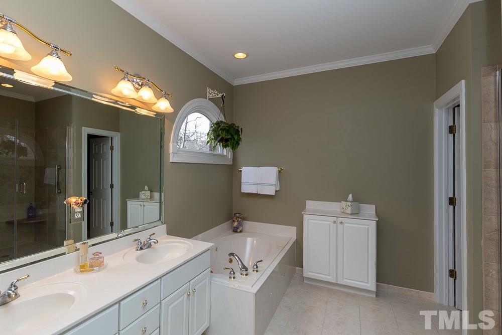 2921 Sunnystone Way Raleigh, NC 27613 - Photo 14 of 25 a bathroom with a sink and a mirror