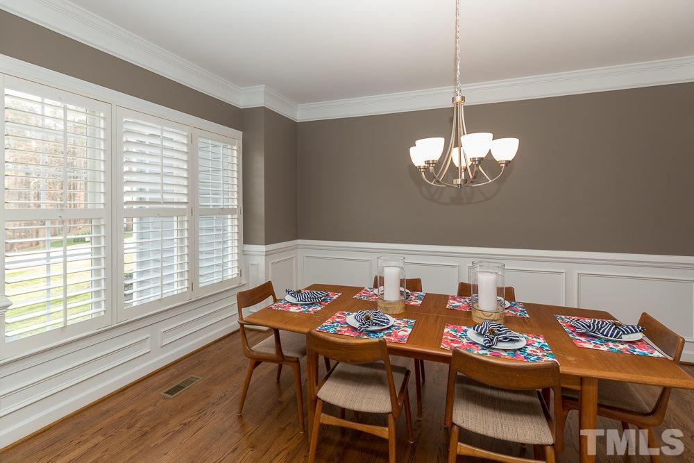 2921 Sunnystone Way Raleigh, NC 27613 - Photo 4 of 25 a view of a dining room with furniture wooden floor and chandelier