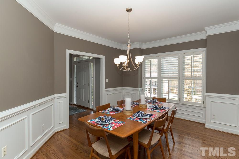 2921 Sunnystone Way Raleigh, NC 27613 - Photo 5 of 25 a view of a dining room with furniture window and wooden floor
