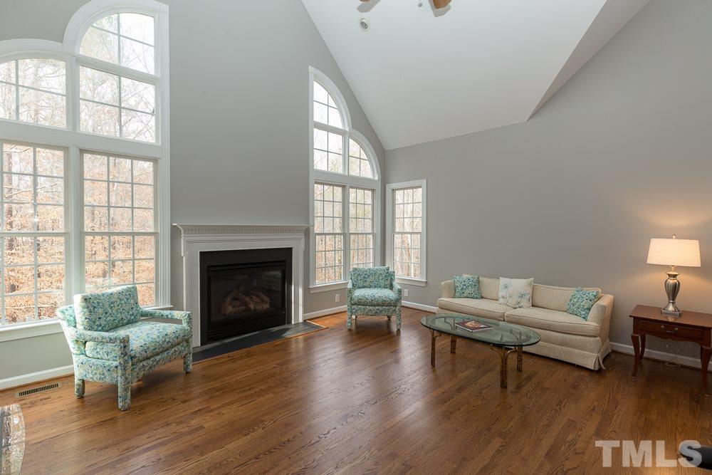 2921 Sunnystone Way Raleigh, NC 27613 - Photo 6 of 25 a living room with furniture and a fireplace