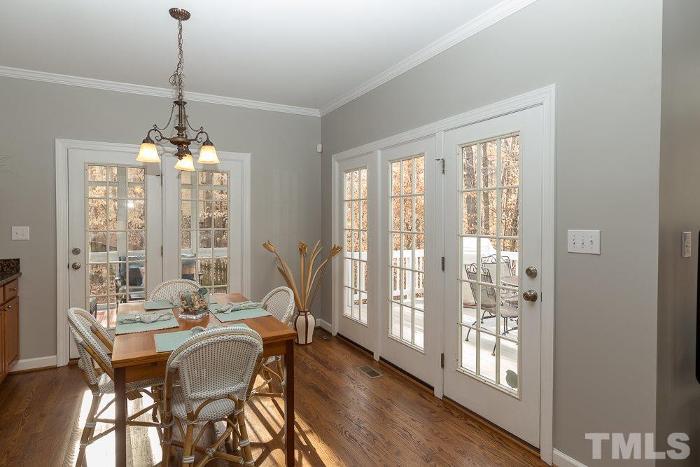 2921 Sunnystone Way Raleigh, NC 27613 - Photo 7 of 25 a view of a dining room with furniture window and wooden floor