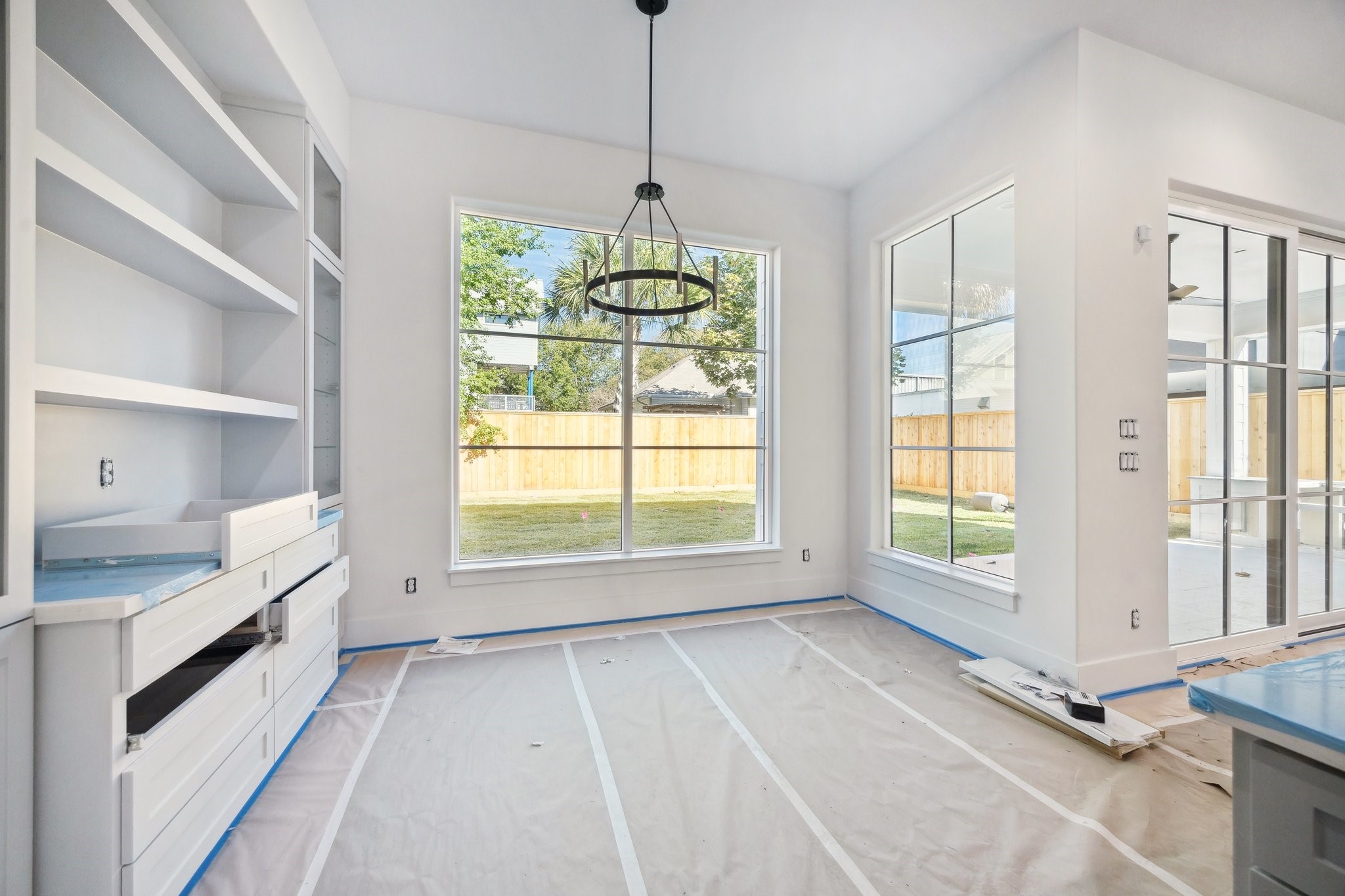 1118 Jackson Boulevard Houston, TX 77006 - Photo 8 of 19 Breakfast Area with Floating Shelves, Built-In Cabinets with Glass Fronted Doors, Glass Shelves and Lighting. There are also under-counter storage drawers and storage cabinets.