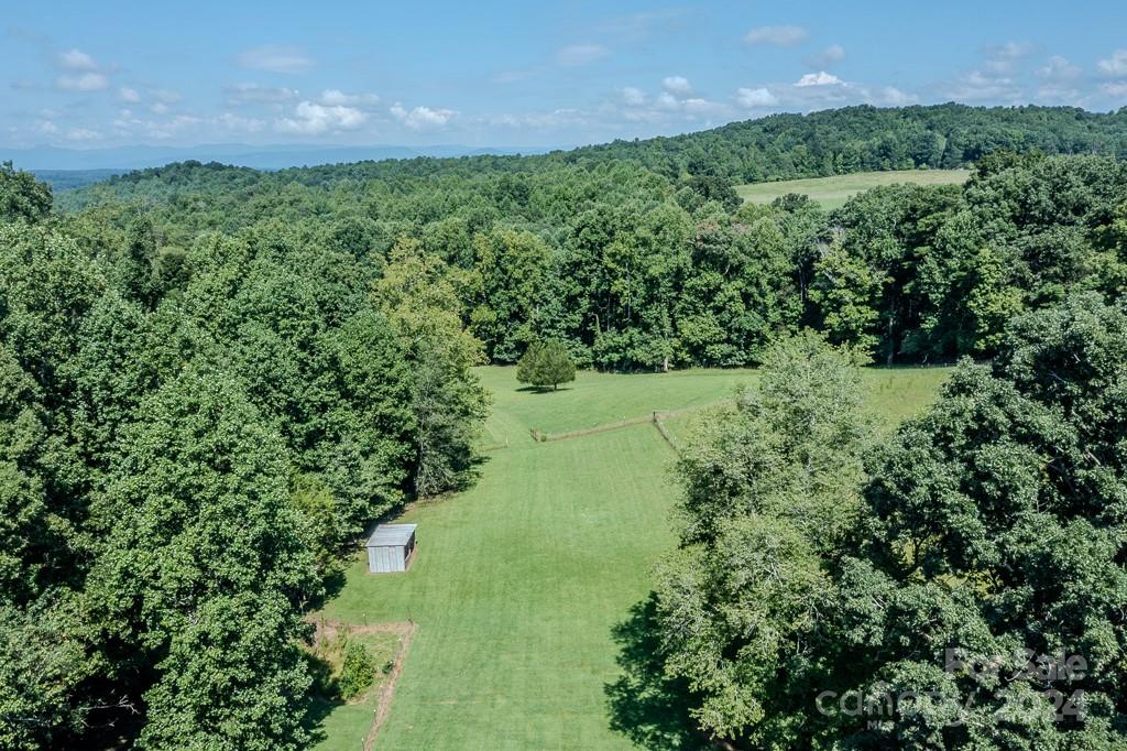 3346 Clarks Chapel Road Lenoir, NC 28645 - Photo 14 of 48 a view of a garden with a building in the background