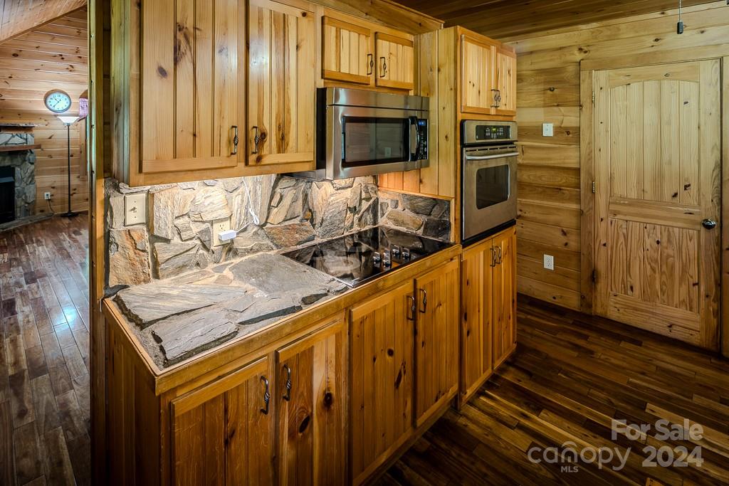 3346 Clarks Chapel Road Lenoir, NC 28645 - Photo 25 of 48 a kitchen with stainless steel appliances granite countertop a refrigerator and a stove top oven