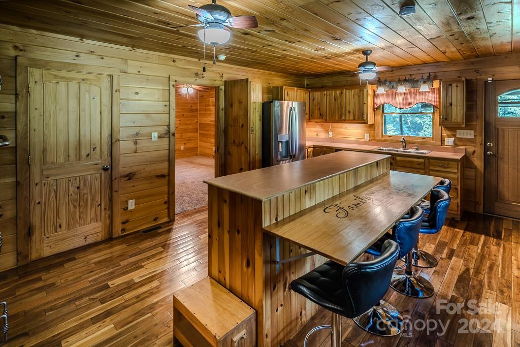 3346 Clarks Chapel Road Lenoir, NC 28645 - Photo 26 of 48 a living room with stainless steel appliances kitchen island granite countertop furniture and a wooden floor