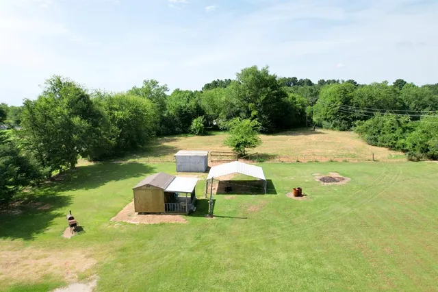 a view of a garden with lawn chairs