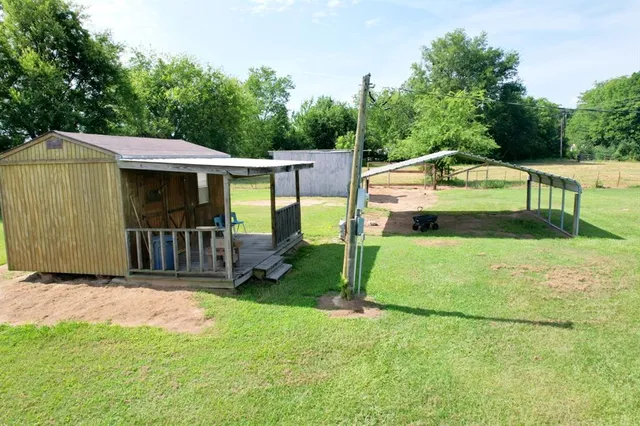 a view of a house with backyard and a patio