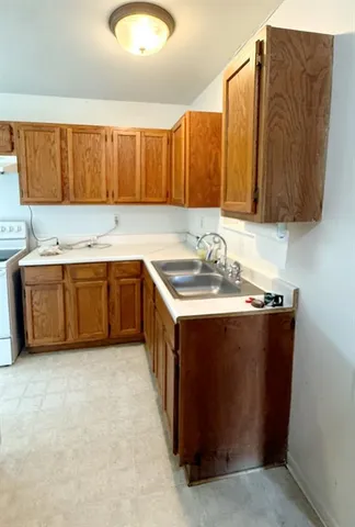 a kitchen with a cabinets and white appliances
