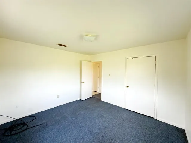 a view of hallway with stairs and furniture