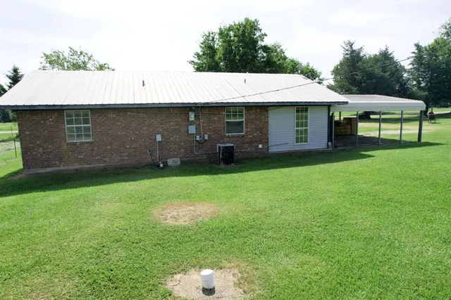 a backyard of a house with table and chairs