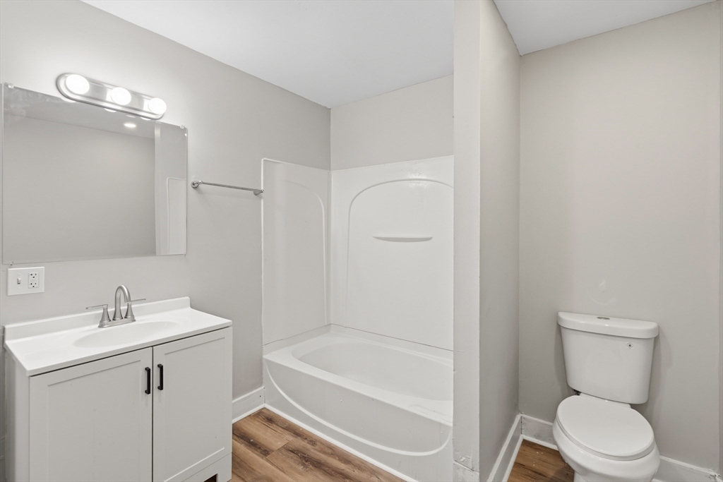 834 Worthington Street, Unit 2 Springfield, MA 01105 - Photo 8 of 20 a bathroom with a sink toilet and vanity