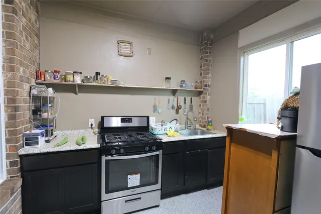 a kitchen with stainless steel appliances a stove and a refrigerator