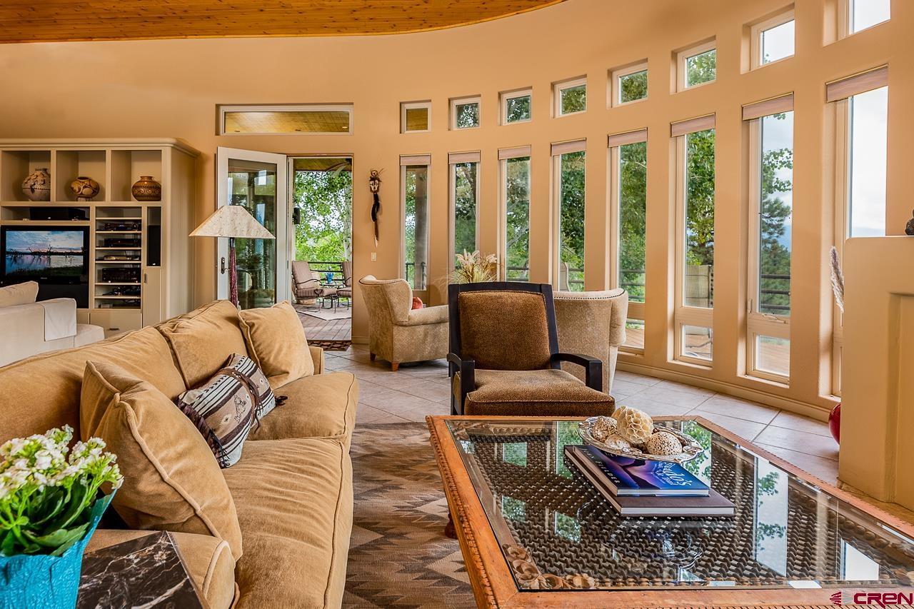 994 Cool Pines Drive Pagosa Springs, CO 81147 - Photo 13 of 35 a living room with furniture fireplace and wooden floor