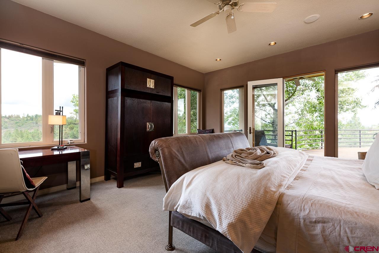 994 Cool Pines Drive Pagosa Springs, CO 81147 - Photo 20 of 35 a bedroom with a bed and a balcony