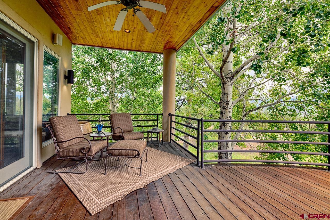 994 Cool Pines Drive Pagosa Springs, CO 81147 - Photo 21 of 35 a view of a patio with table and chairs and wooden floor