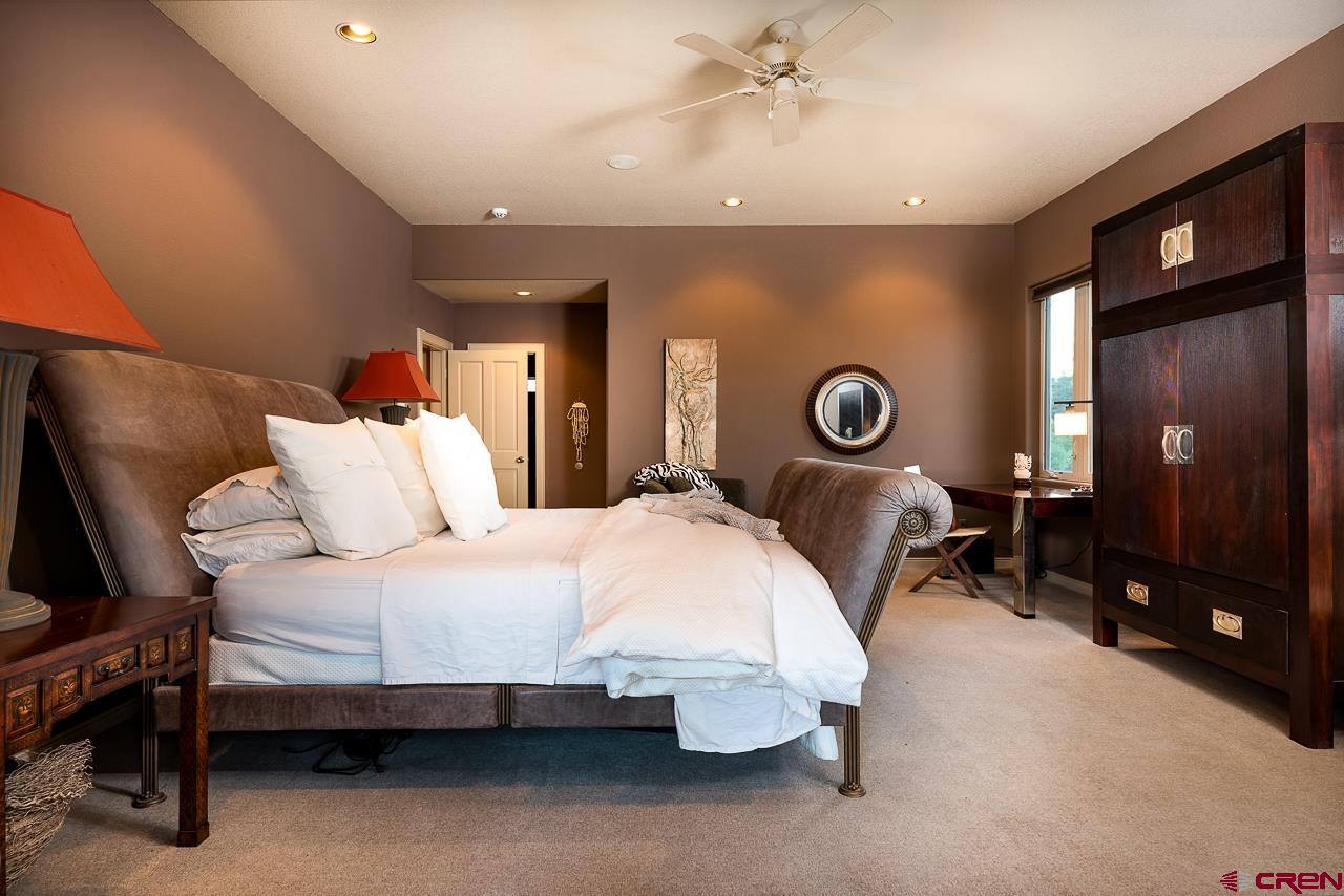 994 Cool Pines Drive Pagosa Springs, CO 81147 - Photo 22 of 35 a bedroom with bed and a chandelier