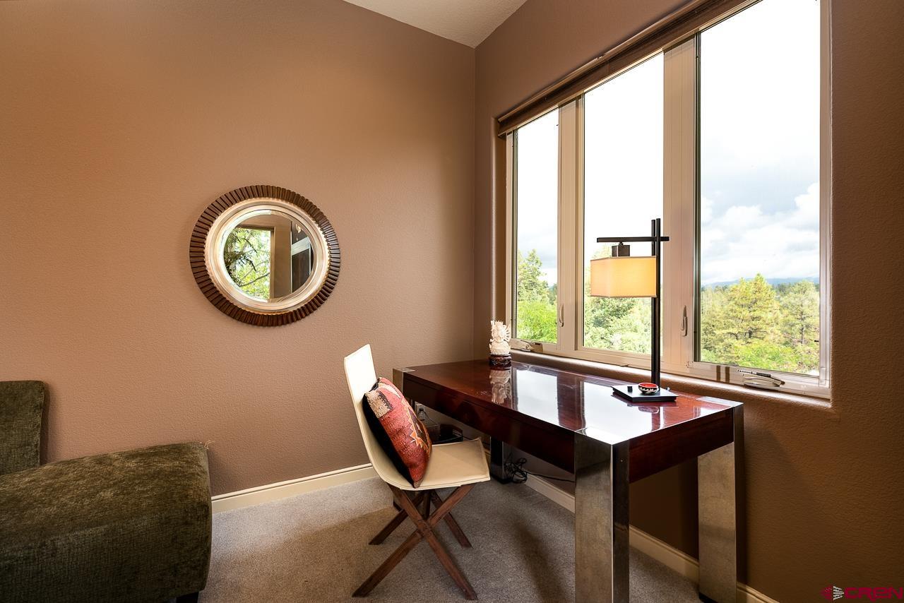994 Cool Pines Drive Pagosa Springs, CO 81147 - Photo 23 of 35 a view of a dining room with furniture and a large window