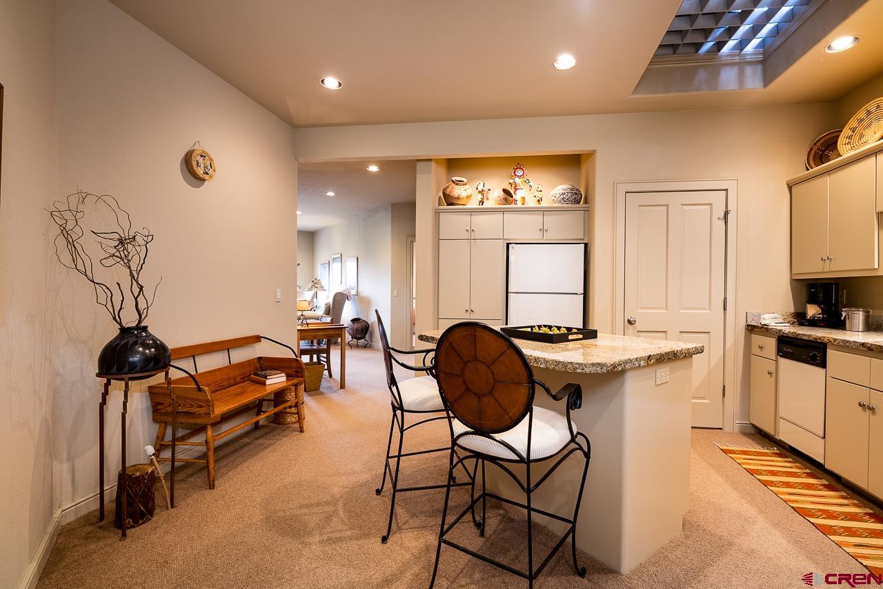 994 Cool Pines Drive Pagosa Springs, CO 81147 - Photo 27 of 35 a kitchen with granite countertop sink cabinets and appliances