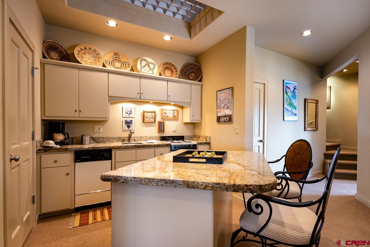 994 Cool Pines Drive Pagosa Springs, CO 81147 - Photo 28 of 35 a kitchen with a refrigerator a stove a sink and a cabinets