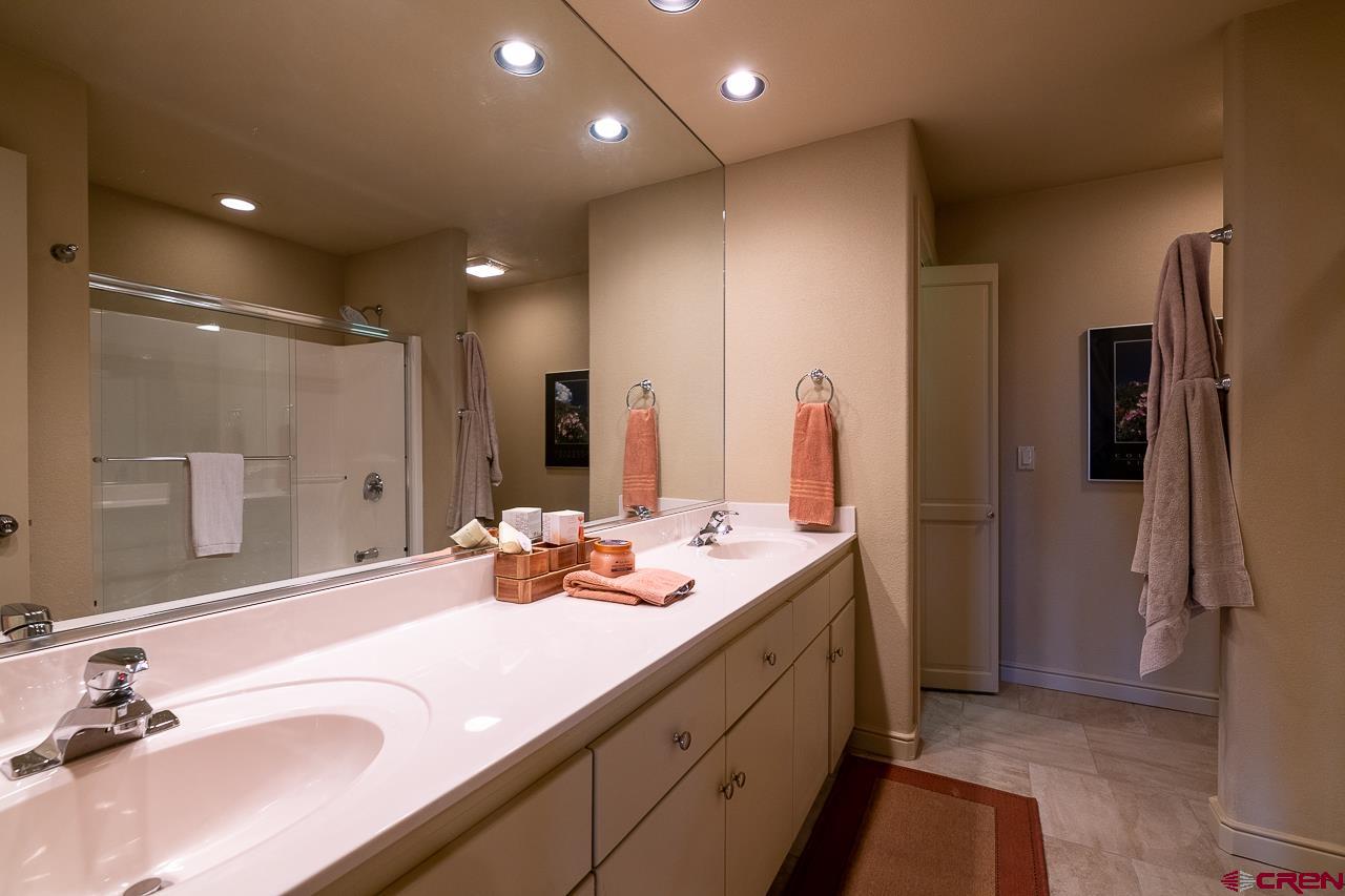 994 Cool Pines Drive Pagosa Springs, CO 81147 - Photo 31 of 35 a bathroom with a double vanity sink and mirror