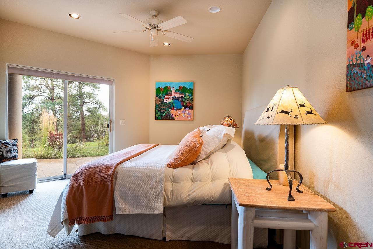 994 Cool Pines Drive Pagosa Springs, CO 81147 - Photo 32 of 35 a bedroom with a bed and a chandelier