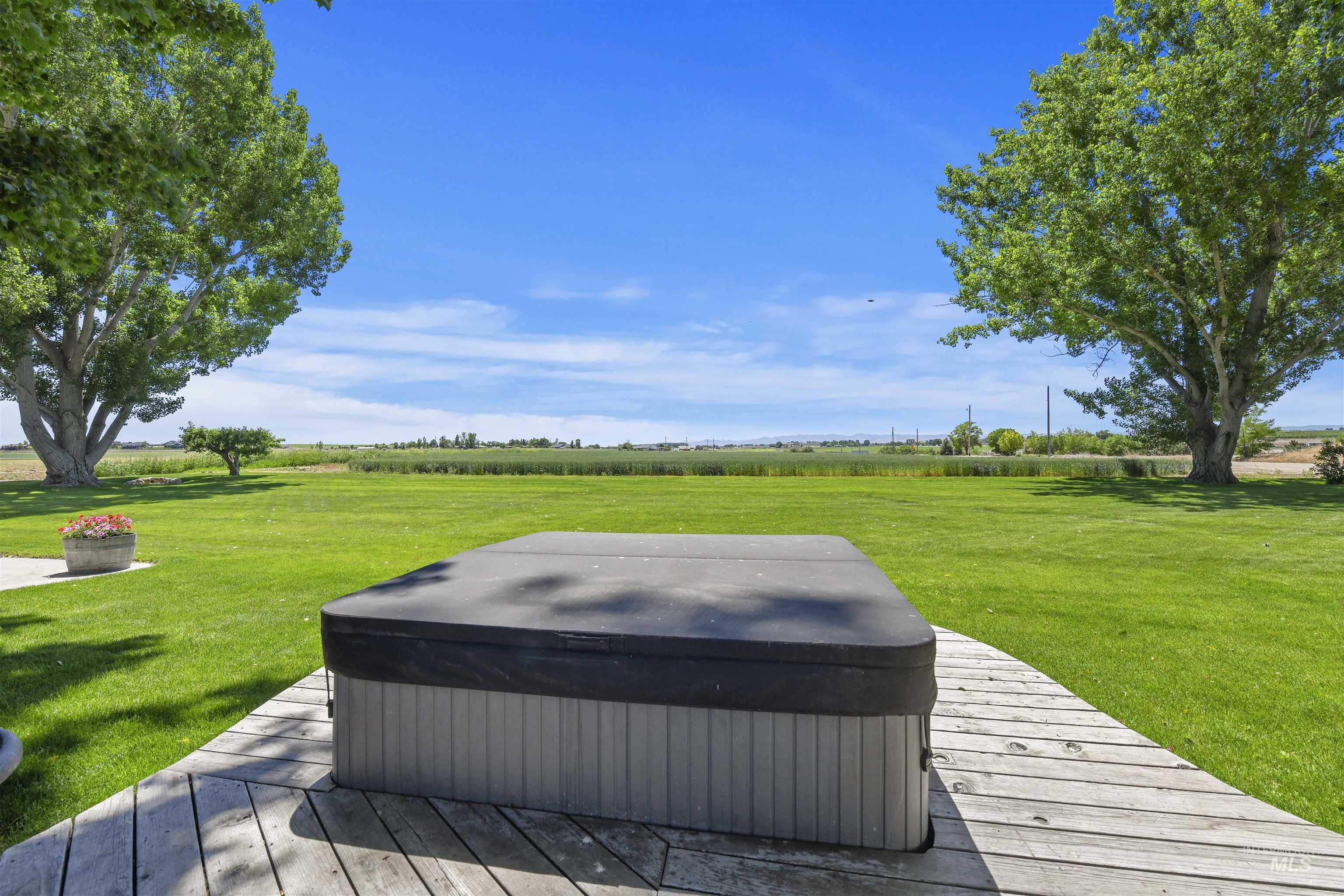 19234 Top Road Caldwell, ID 83607 - Photo 19 of 50 Deck with a yard, a view of rural / pastoral area, and a hot tub