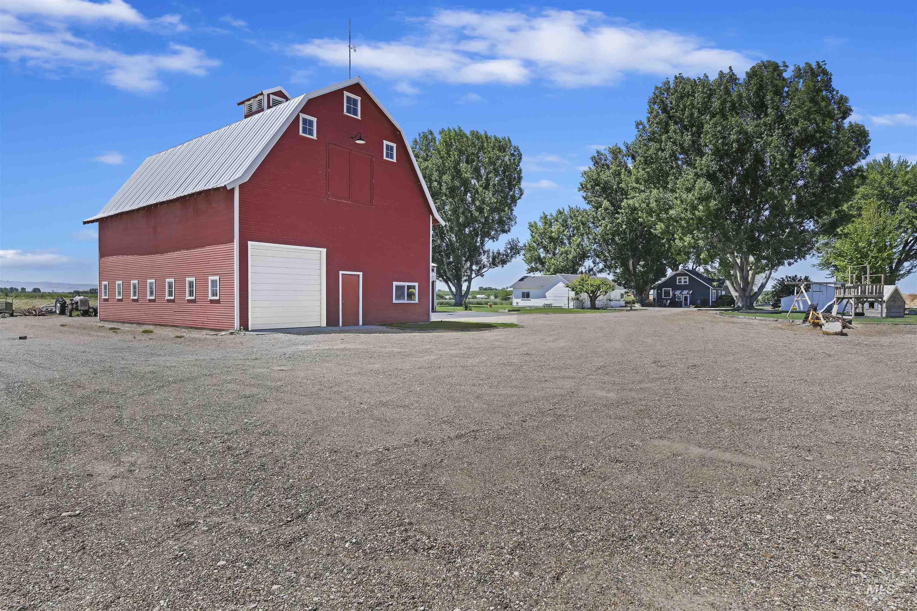 19234 Top Road Caldwell, ID 83607 - Photo 32 of 50 View of barn featuring driveway and a residential view