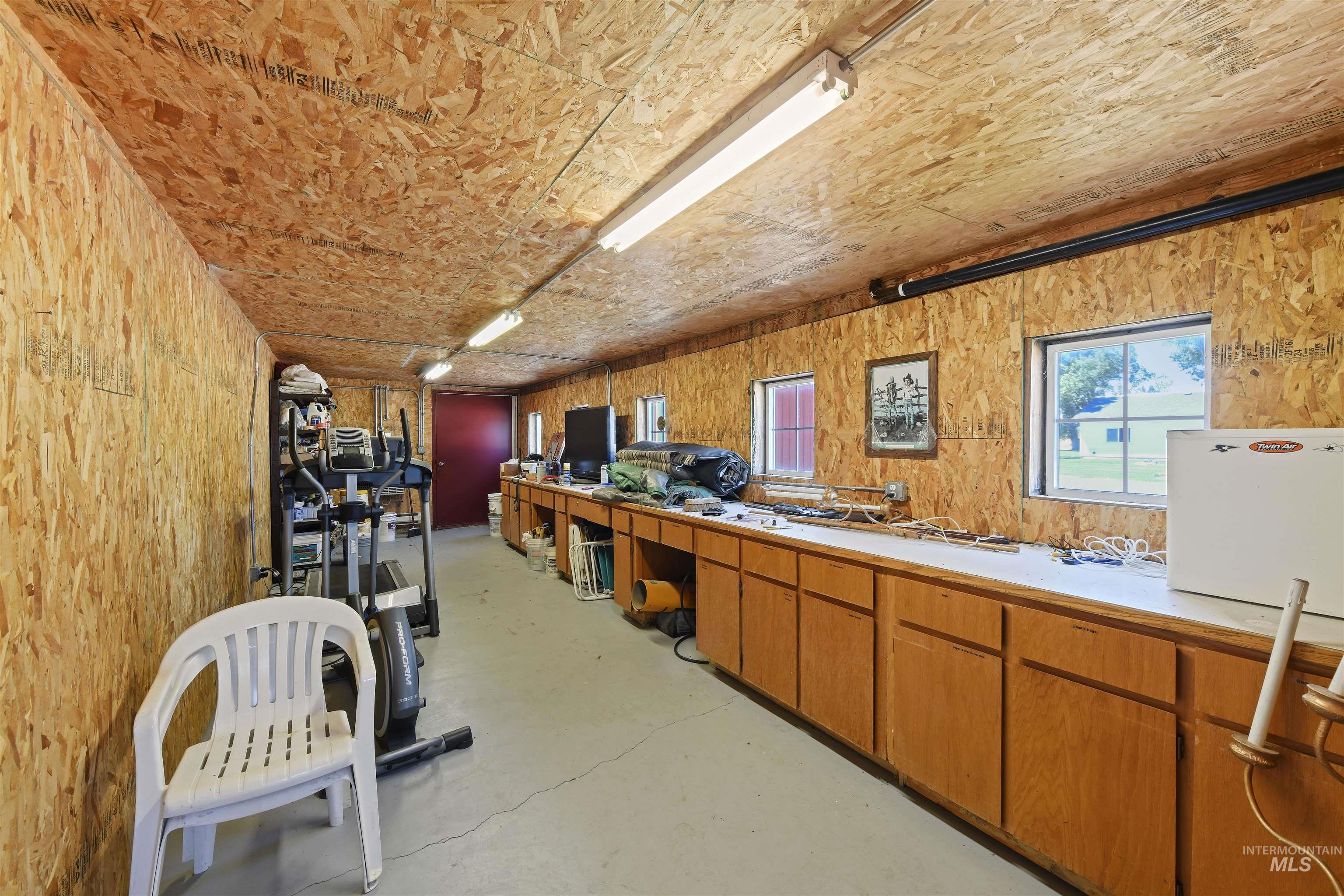 19234 Top Road Caldwell, ID 83607 - Photo 34 of 50 Miscellaneous room featuring concrete flooring and wood walls