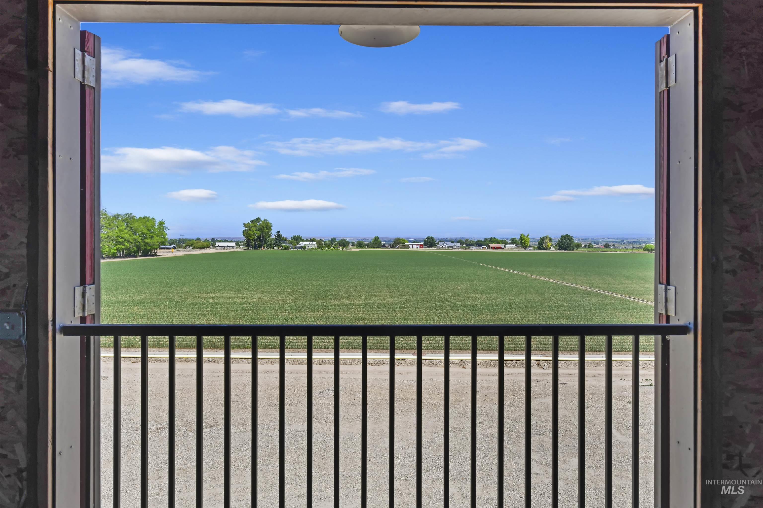 19234 Top Road Caldwell, ID 83607 - Photo 36 of 50 View of yard featuring a balcony and a view of countryside